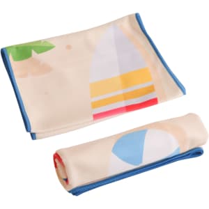 Microfibre beach towel in cream with colourful designs, featuring a surfboard and beach ball. Includes a logo.