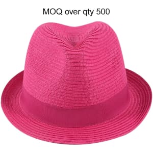 A pink straw hat with a wide brim and a decorative band, featuring a logo. Perfect for sunny days.
