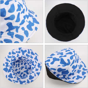 A cow print bucket hat featuring a blue and white design with a black inner lining. Includes a logo.