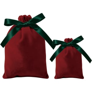 Two red velvet drawstring gift bags, one large and one small, both adorned with green satin ribbons.
