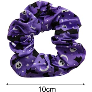 A purple hair scrunchie with a pattern of skulls, bats, and stars. It has a diameter of 10 cm and features a logo.