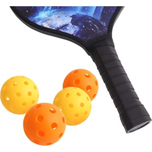 A wooden pickleball paddle with a cosmic design and three perforated balls in orange and yellow.