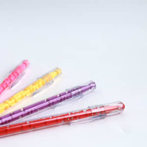 A set of colourful pens in pink, yellow, purple, and red, each featuring a maze design on the barrel.
