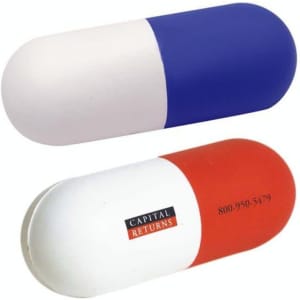 A capsule-shaped stress reliever in blue and white on one side, red and white on the other, featuring a logo.