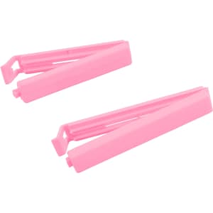 Two pink Medium Food Bag Seal Clips are positioned together, featuring a simple design and a small logo.
