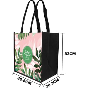 A tall non-woven tote bag featuring a floral design in pink and green, with black sides and handles.