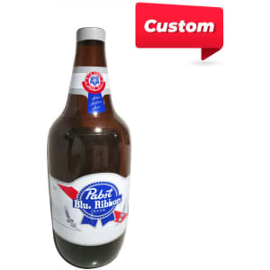 A large inflatable drink bottle in brown, red, white, and blue, with a logo featured on the front.