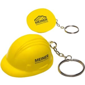 A yellow keyring featuring a helmet-shaped stress reliever and a round keychain, both with logos.