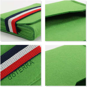 A green felt travel organiser with a striped band and a logo. Compact and designed for essential oils storage.