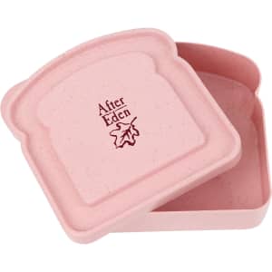 A pink portable bamboo fibre lunch box shaped like a slice of bread, with an embossed logo inside.