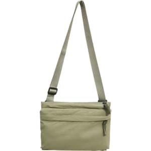 A lightweight crossbody bag in a muted beige colour with an adjustable strap and a zippered front pocket.