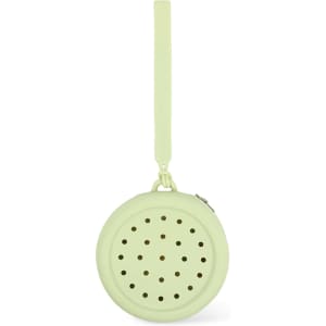 A round silicone pouch in a soft green colour with perforated holes and a strap for easy carrying.