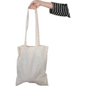 A long-handled calico bag in off-white being held by a hand, featuring a simple design and subtle branding.