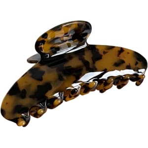 A tortoiseshell acetate hair clip with a curved design and multiple gripping prongs.