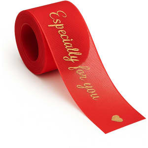 A roll of red organza ribbon featuring gold text and a heart shape.