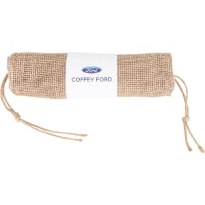 A jute net produce bag, rolled and tied with twine, featuring a logo on a white label.