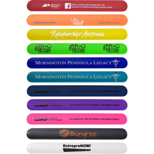 A collection of silicone slap bands in various colours, featuring logos and text from different organisations.