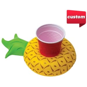 An inflatable cup holder shaped like a yellow pineapple, featuring a green leafy top and a red cup.