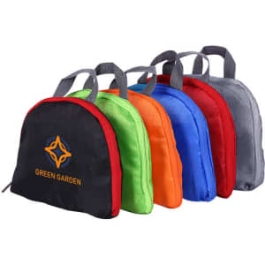 A set of five compressed bags in black, green, orange, blue, and grey, featuring a logo on one.