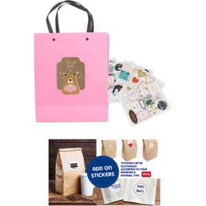 A pink laminated handle bag with a cute design, accompanied by decorative stickers and a coffee bag.