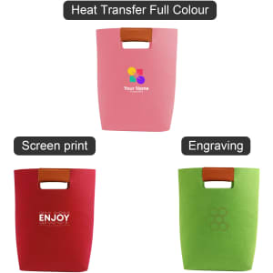 A pink, red, and green felt tote bag feature rounded handles and various decorative styles, including logos.