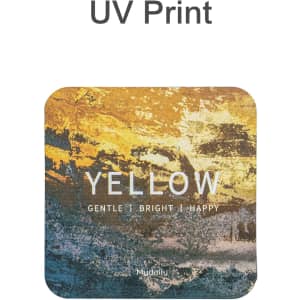 A square frosted metal coaster in yellow and earthy tones features a design with textured colours and a logo.