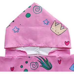 A pink hooded change towel featuring playful designs like hearts, stars, and a crown. It has a logo on it.