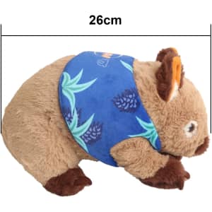 A brown wombat plush toy with a blue patterned scarf, measuring 26cm in length. Features a logo on the scarf.
