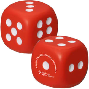 A red dice-shaped stress reliever with white dots, featuring a logo on one side.