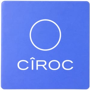 A blue cork coaster with a circular logo and branding.