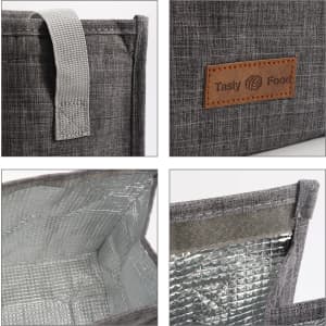A grey minimalist lunch bag with a textured exterior, a leather-like tag, and a silver insulated interior.