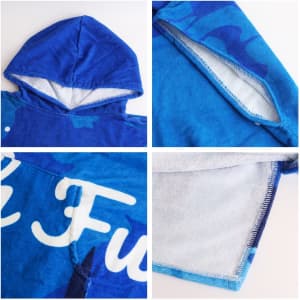 A blue cotton surf poncho featuring a hood and soft inner lining, with a logo and decorative patterns.