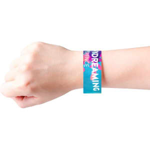 A disposable full-colour Tyvek wristband in turquoise and pink on a wrist, featuring a logo.