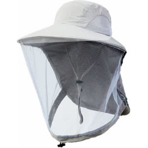 A lightweight beige hat with a transparent mesh face shield and a logo on the side.