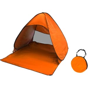 An orange pop-up beach tent with a rounded canopy and a matching compact carry bag.