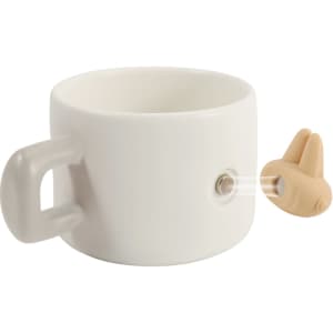 A white ceramic mug with a handle and a magnetic feature on the side, accompanied by a small brown attachment.