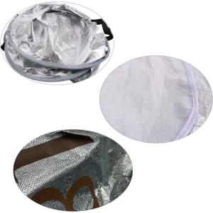 A round aluminum car snow cover in silver, featuring a textured interior and black straps for securing.