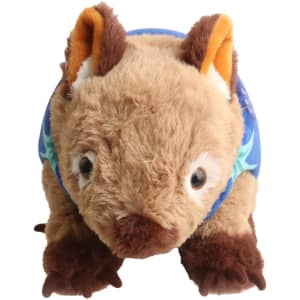 A brown and cream wombat plush toy wearing a blue floral shirt, with large ears and friendly eyes.