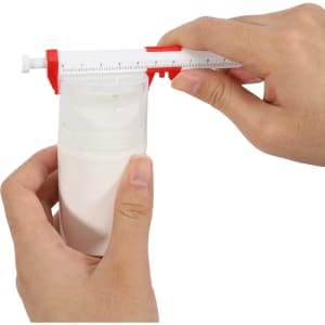 A caliper pen in red and white being used to measure the height of a white bottle, held in two hands.