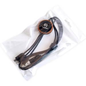 A round shape charging cable in a clear bag, featuring a black colour with an orange accent and a logo.