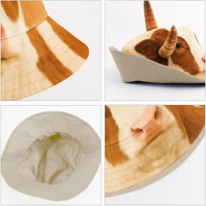 A bucket hat featuring a cow design with brown and white patterns, complete with animal ears and a neutral interior.