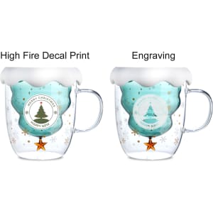 A double wall mug featuring a Christmas tree design, teal colour with a white frosted rim and a handle.