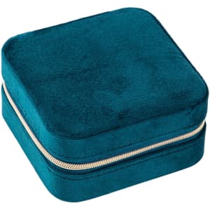 A velvet jewellery organiser in a rich teal colour, featuring a zip closure and a soft texture.