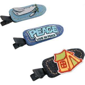 Three denim duck bill hair clips featuring various embroidered designs in blue and multi-colours. They have attached black clips.