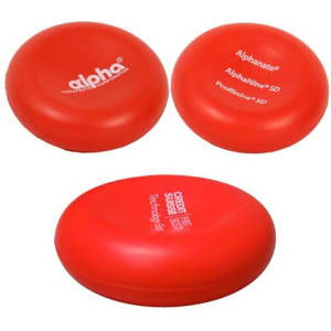 A red stress reliever in a circular shape, featuring a logo, with a smooth surface and slight sheen.