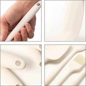 A collection of cream-coloured silicone kitchen utensils, including a spatula, brush, and various handles, with one held in a hand.