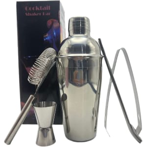 A drink bottle with a shiny silver cocktail shaker, strainer, jigger, tongs, and packaging in the background.