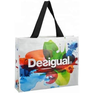 A laminated non-woven trade show bag featuring a vibrant design with splashes of colour and a black strap.