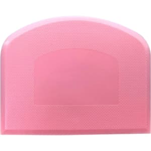 A pink flexible bowl scraper with a textured surface and a rounded top, featuring a logo.