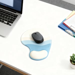 A lightweight gel mouse pad in blue and cream, with a computer mouse resting on it, placed on a desk.